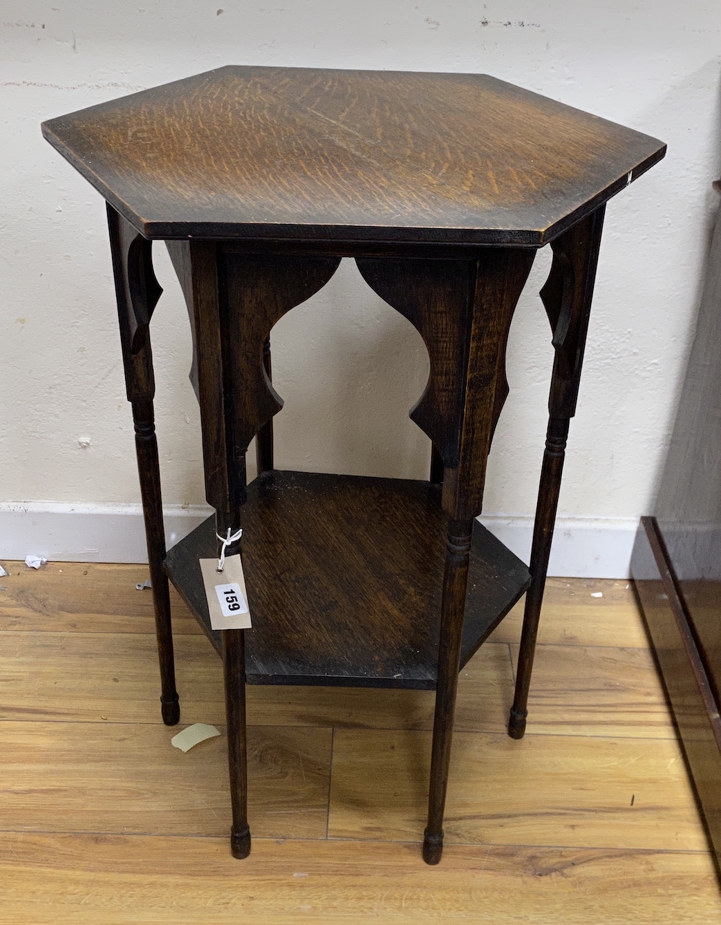 An early 20th century Liberty style hexagonal oak two tier occasional table, width 51cm, height 70cm